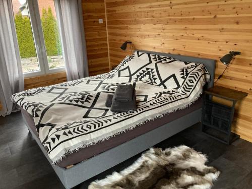 a bedroom with a bed with a dog laying on the floor at Hagens Cottage in Wanfried