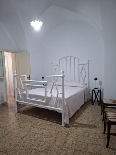 a bedroom with a white bed in a room at Casa Teresina in Cannole