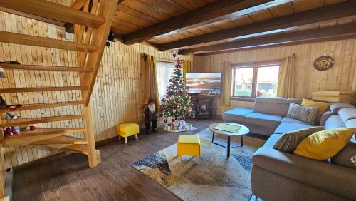 a living room with a christmas tree and a couch at Holiday Home BIBA With Heated Outdoor Pool in Gornja Stubica