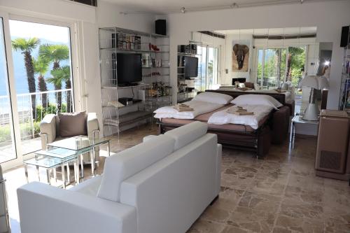 a bedroom with a bed and a living room at Casa Bellavista Rovio in Rovio