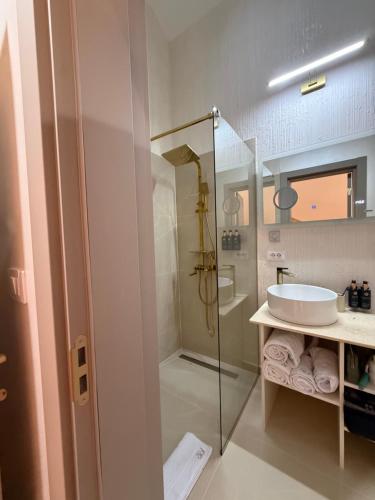 a bathroom with a glass shower and a sink at Sadova Loft View in Sadova