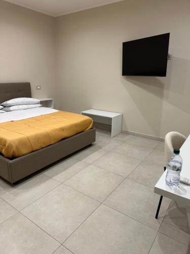 a bedroom with a bed and a tv on a wall at Souad 2 in San Prisco