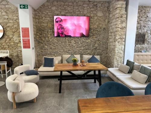 a living room with a table and couches at Marevita Hostel-Quiet & super hygienic hostel with privacy beds-Ideal for winter stays in Alicante