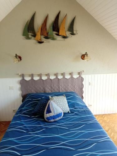 a bedroom with a bed with sails on the wall at Ferme de Bopérec in Nostang
