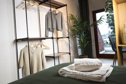 a room with a display rack with clothes at Nalia Homes - Elegant Central Apartment in Pinneberg