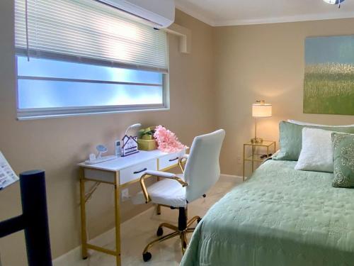 a bedroom with a desk and a bed and a bed and a desk and chair at Beautiful Days in Orange Park