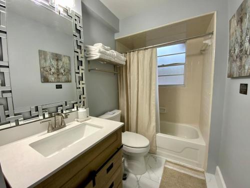 a bathroom with a sink and a toilet and a tub at Beautiful Days in Orange Park