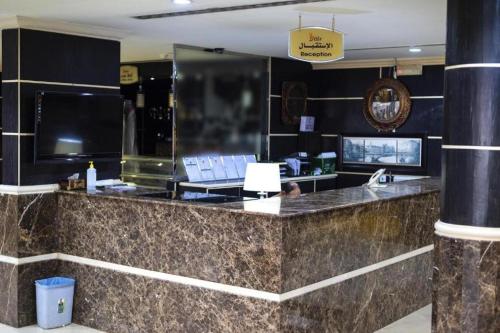 a lobby with a counter with a laptop on it at Quiet Rooms 8 Serviced Apartments in Riyadh