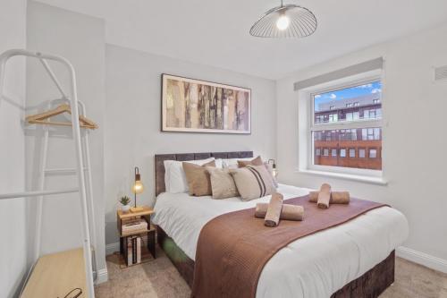 a bedroom with two beds and a window at Modern 2 Bed Apartment, Secure Parking, Central in Hemel Hempstead