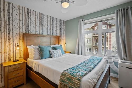a bedroom with a large bed and a window at 2 Bedroom Condo Banff, Canmore sleeps 6 comfortably in Canmore