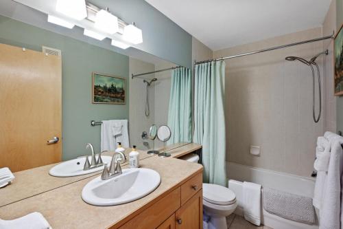 a bathroom with a sink and a toilet and a shower at 2 Bedroom Condo Banff, Canmore sleeps 6 comfortably in Canmore