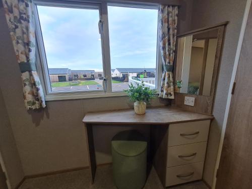 a desk in a room with a window at Silversands - Private Caravan Let in Lossiemouth