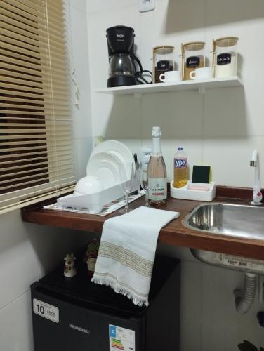 a kitchen counter with a sink and a towel at Casa Mari Suites in Canoa Quebrada