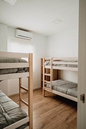 a room with three bunk beds in a room at Villa alegre in Elche