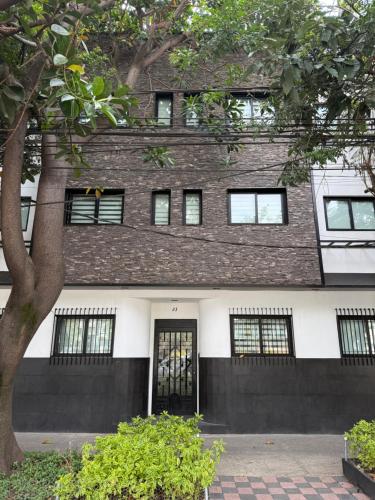 a building with a black and white at Narvarte Living in Mexico City