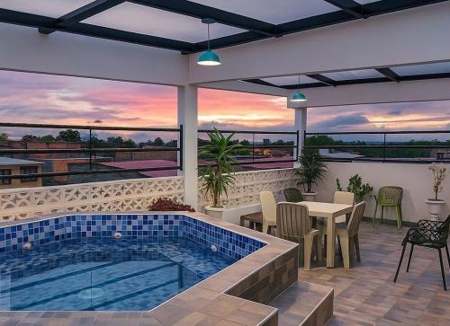 ein Haus mit einem Pool und einer Terrasse mit einem Tisch in der Unterkunft Wiky House Guaduas in Guaduas