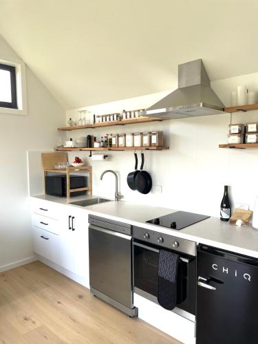 a kitchen with a sink and a stove at NEW Luxury Cabin with Scenic Views & Farm Charm in Huonville