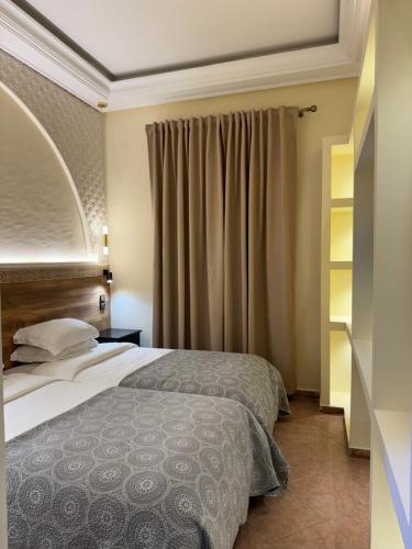 a hotel room with two beds and a window at Darna Boutique Hôtel- Newly Renovated in Rabat