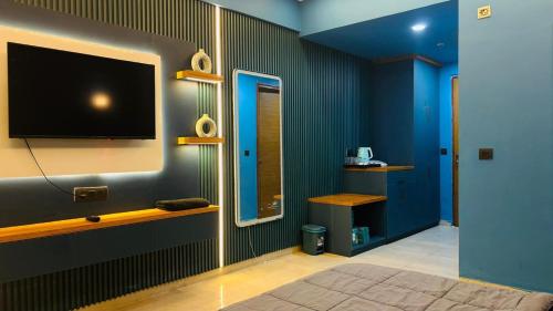 a room with a flat screen tv on a wall at Celestia Grand in Lucknow