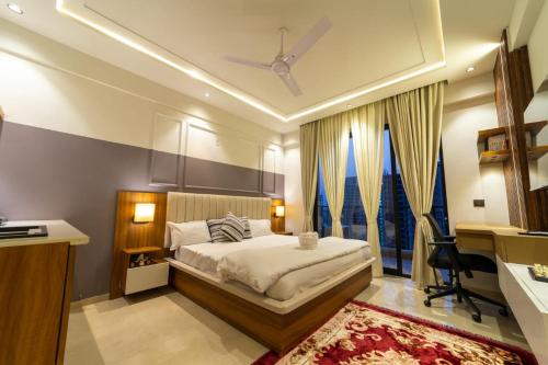 a bedroom with a bed and a large window at Celestia Grand in Lucknow