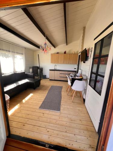 a living room with a couch and a table at Pond Cabin 