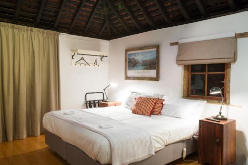 a bedroom with a large bed and a window at Ratho Farm in Bothwell