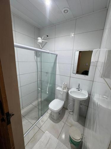 a bathroom with a toilet and a shower and a sink at POUSADA DEUS É FIEL Coruripe in Coruripe