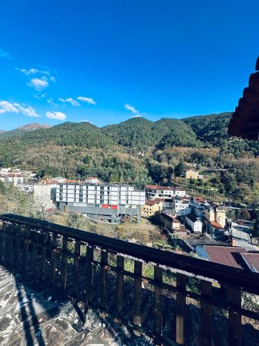a view of a city with mountains in the background at Mountain View Guest House,Geres in Geres