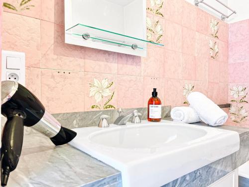 a bathroom with a sink and a bottle of wine at Cannes Montfleury - Comfortable accommodation Center in Cannes