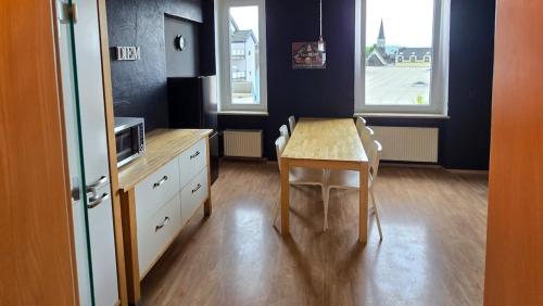 a small kitchen with a table and a microwave at Room 4 - shared house in Linz am Rhein