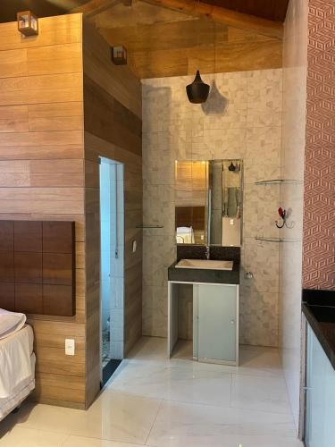 a bathroom with a sink and a mirror at Pousada Hibiscos in Serra do Cipo
