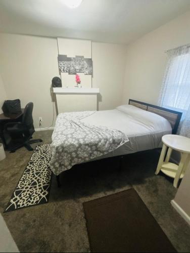 a bedroom with a bed and a desk and a chair at McDaniel House Private Room 6 Shared Bathroom in Atlanta