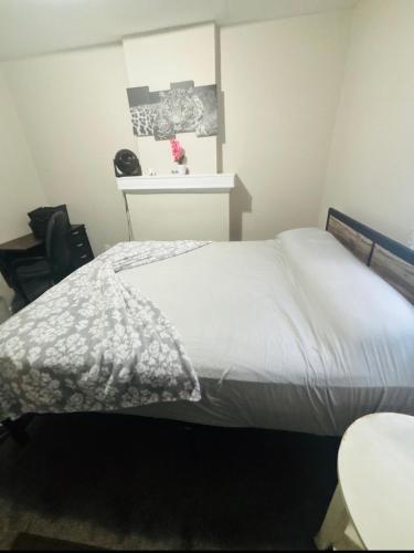 a bedroom with a white bed and a table at McDaniel House Private Room 6 Shared Bathroom in Atlanta