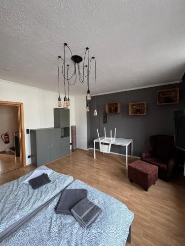 a bedroom with a bed and a living room at DoubleRoom shared house 1 floor in Linz am Rhein