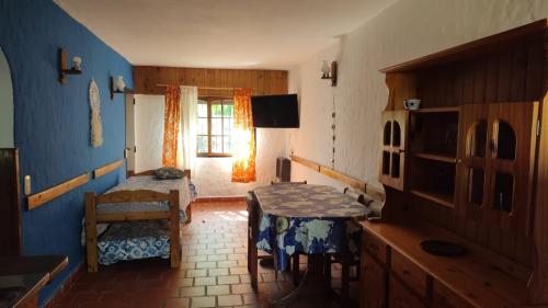 a room with a bed and a table and a window at Amistad in Villa Gesell