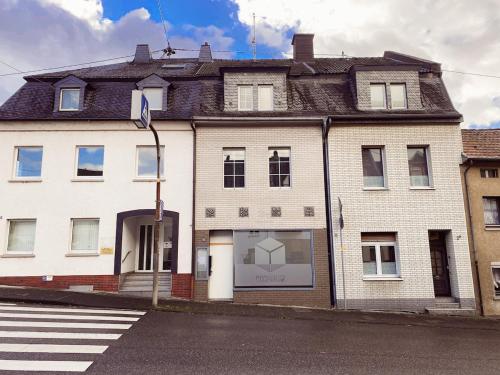 a large white building on a city street at DoubleRoom - work and stay - shared house - 2floor in Linz am Rhein