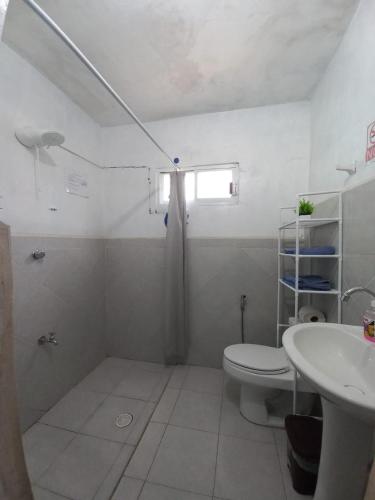 a bathroom with a toilet and a sink at white house in Valladolid