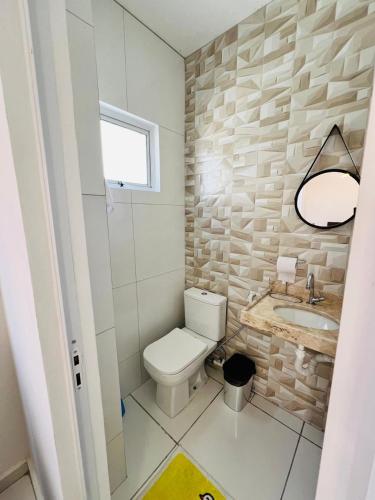 a bathroom with a toilet and a sink at Casa duplex em condomínio Parnaiba in Parnaíba
