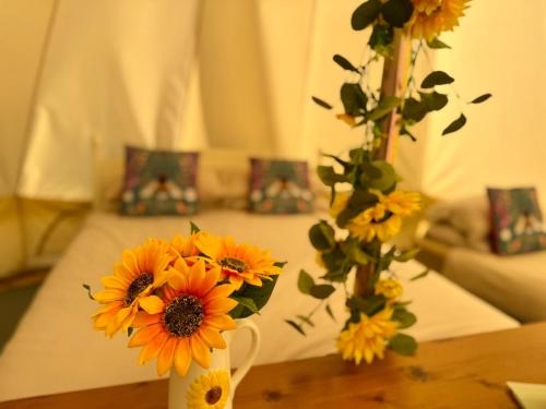a vase filled with yellow flowers on a table at The Beehive in Narberth