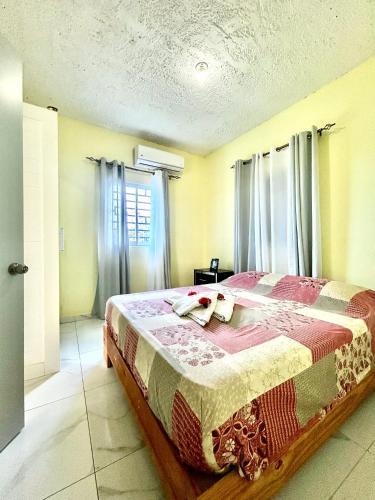 a bedroom with a bed in a room with windows at Apartamentos-Oliver in Las Galeras
