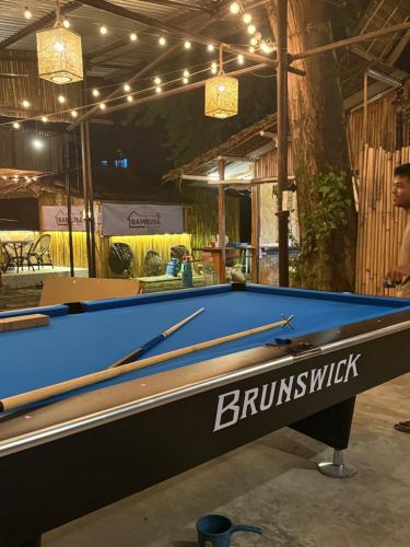 un tavolo da biliardo blu in una stanza con luci di Bonbon Beach House a Liloan