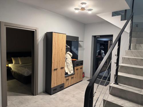 a bedroom with a bed and a staircase next to a stair case at cottages GRUN in Yablunytsya