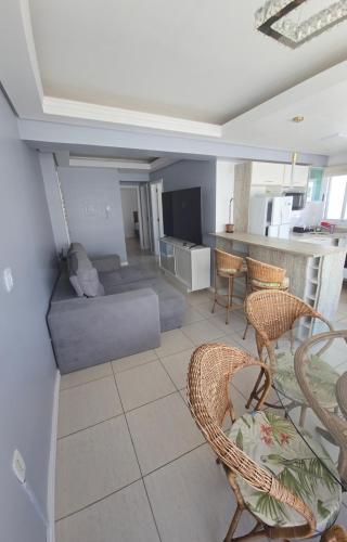 a living room with a couch and chairs at Dona Iva in Capão da Canoa