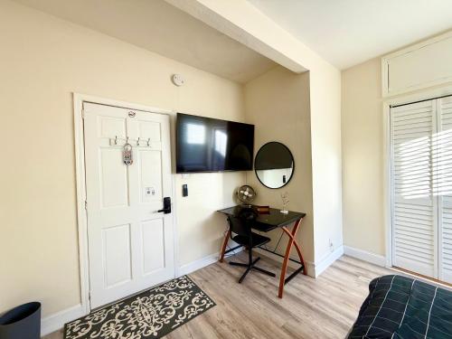 a room with a door and a table and a mirror at 2-A Diamond in Yonkers in Yonkers