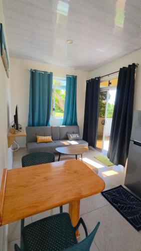 a living room with a couch and a table at AK Lodge Raiatea in Raiatea
