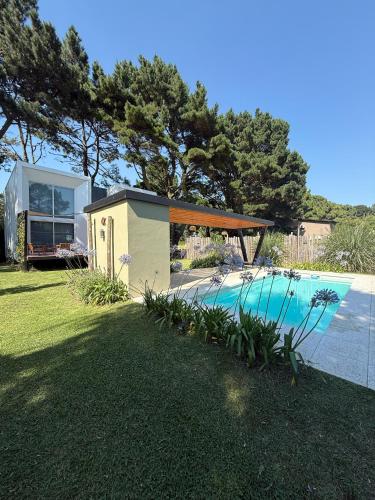 una piccola casa con piscina in un cortile di Complejo Raíces a Mar de Cobo