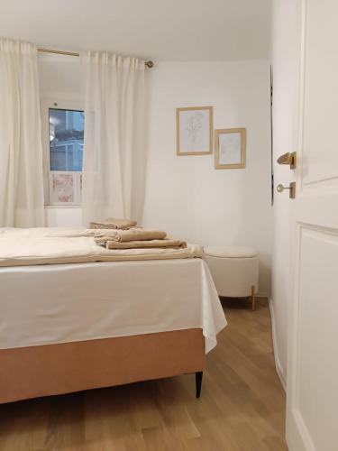 a white room with a bed and a window at Paulla in Šibenik