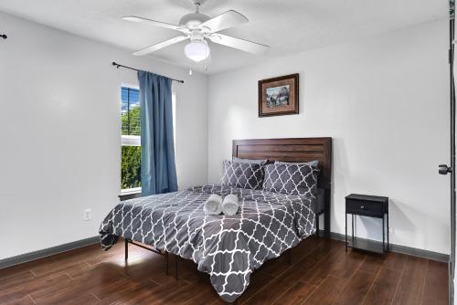a bedroom with a bed and a ceiling fan at 6 Bedroom house 15 minutes from iah airport. in Houston
