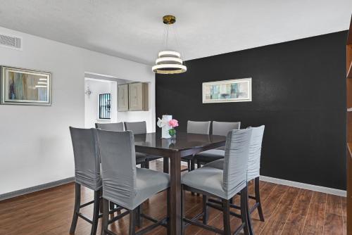 a dining room with a table and chairs at 6 Bedroom house 15 minutes from iah airport. in Houston
