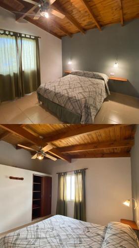 two beds in a bedroom with wooden ceilings at Complejo de cabañas El Nido in Mina Clavero